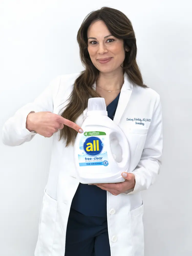 picture of Dr. Lindsey Zubritsky, doctor holding all bottle wearing a white lab coat