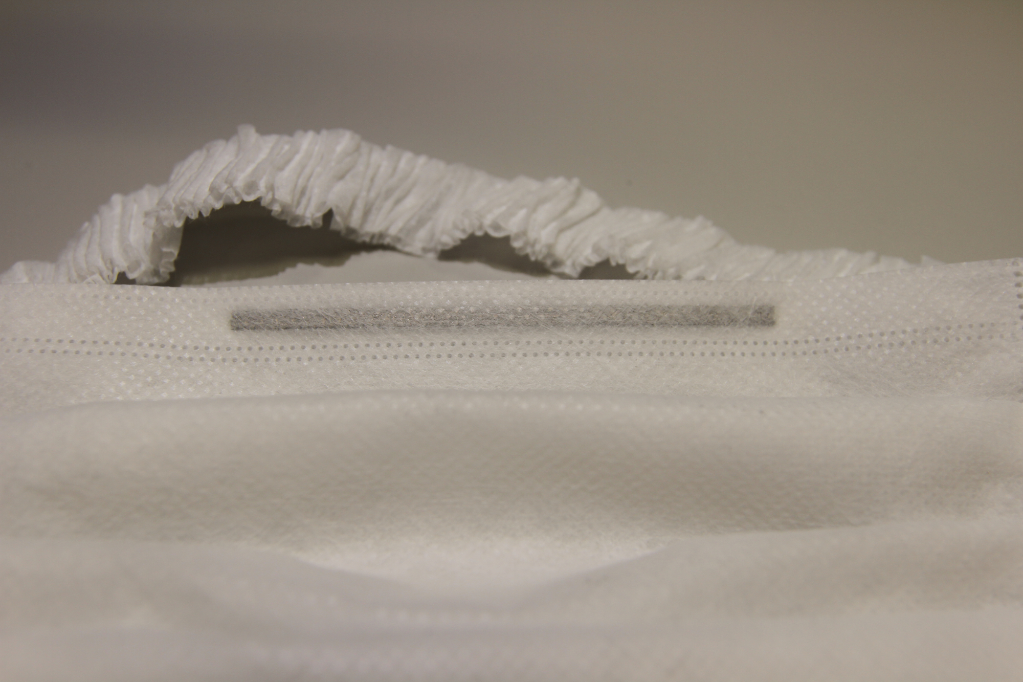 The patent-pending face mask developed by Curt G. Joa, Inc. relies on Henkel adhesives to secure the nose wire in place.