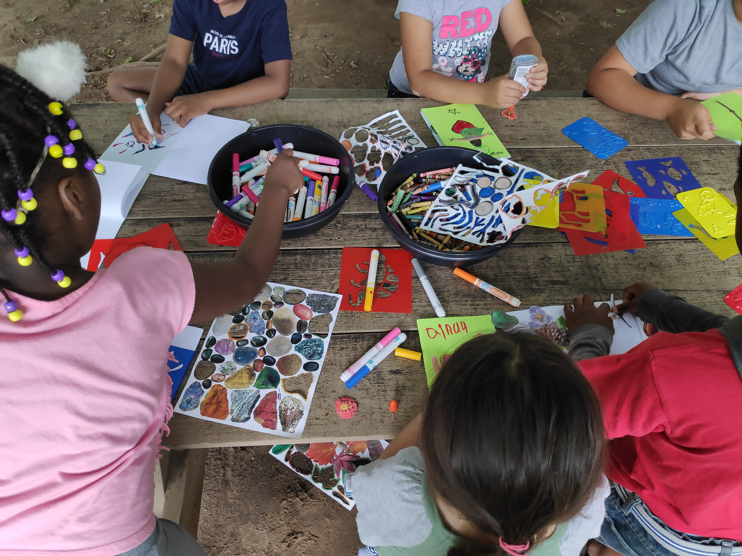 Children seated at table drawing