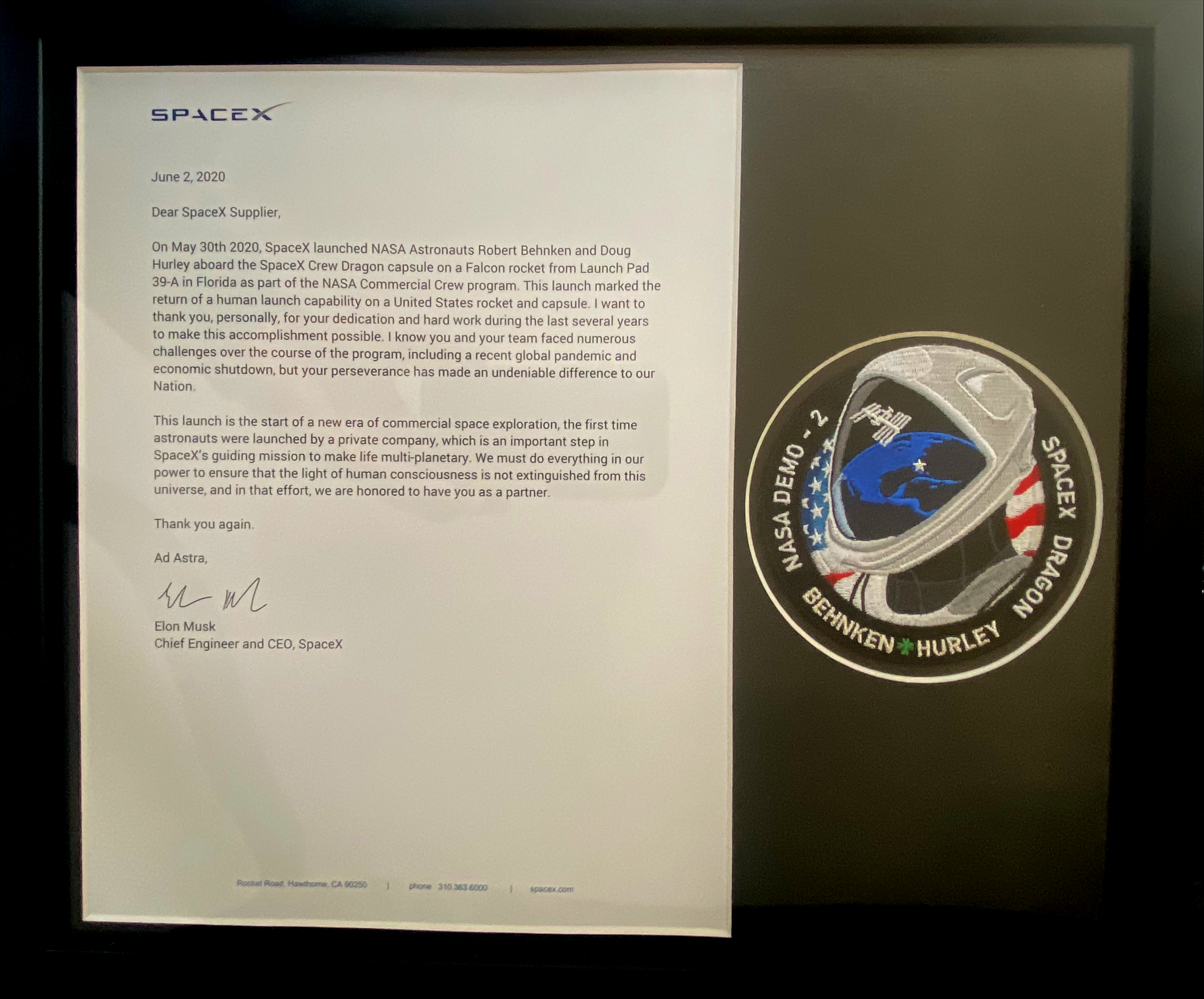 A letter from SpaceX CEO Elon Musk hangs on the wall at the Chanhassen facility thanking the team members for their contributions as a supplier to their program with NASA.