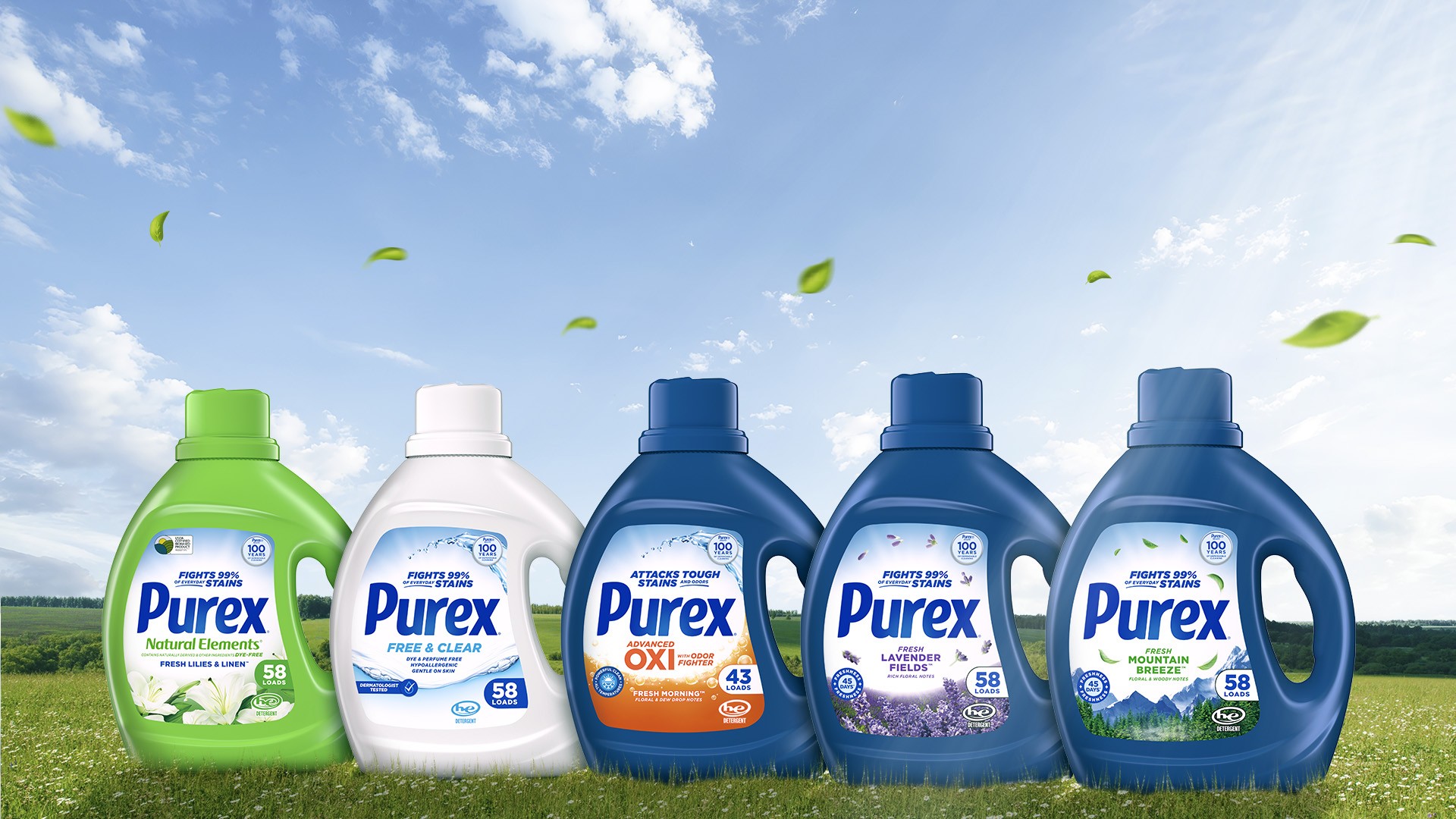 Five Purex liquid laundry detergent bottles lined up on grass under a blue sky, showing different varieties: Natural Elements, Free & Clear, Oxi, Lavender Fields, and Mountain Breeze.