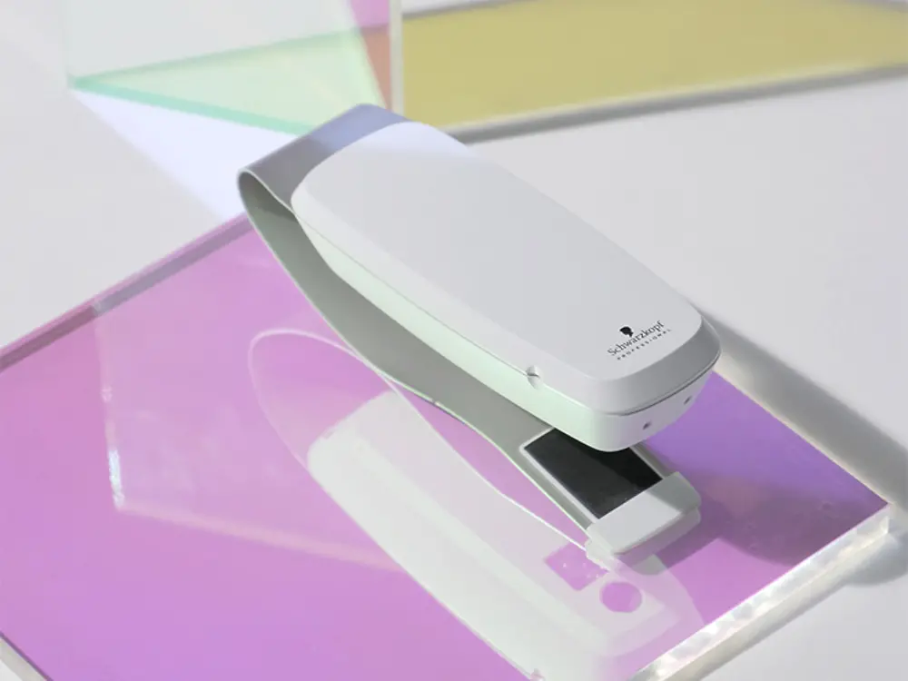 SalonLab Smart Analyzer displayed on colorful background. 