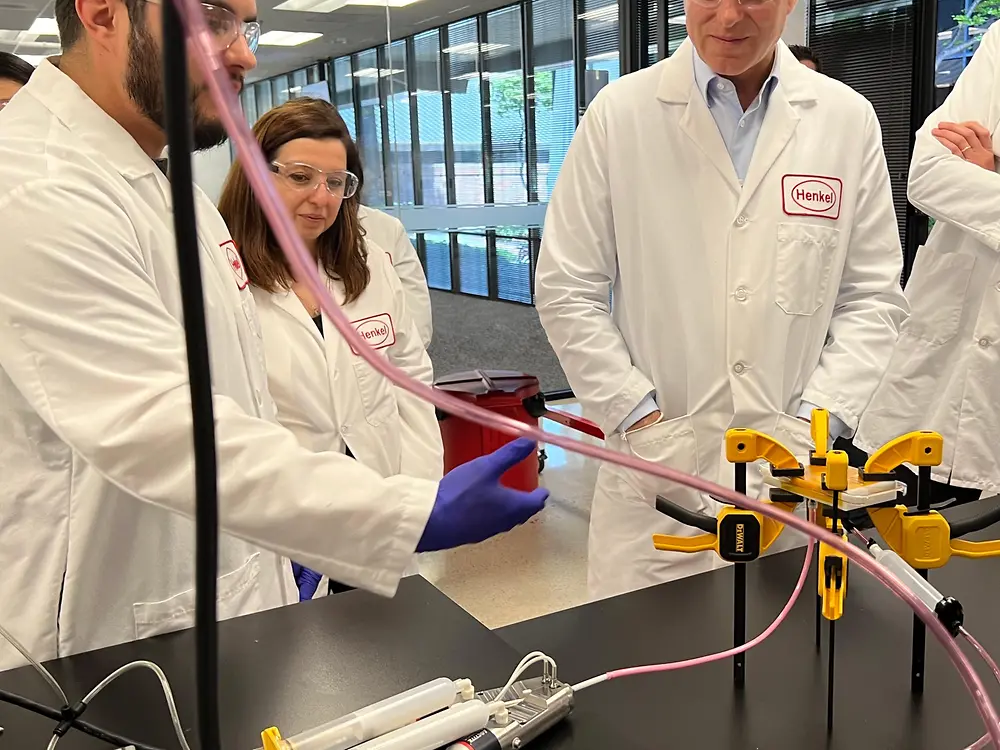 Henkel application engineers perform a color-matched adhesives demonstration at the new Technical Application Center.