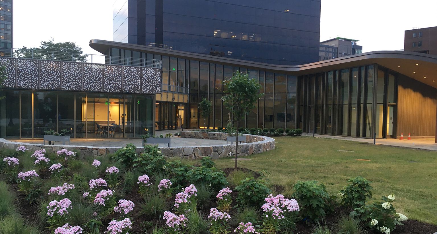 Flower bed in foreground of building with glass walls