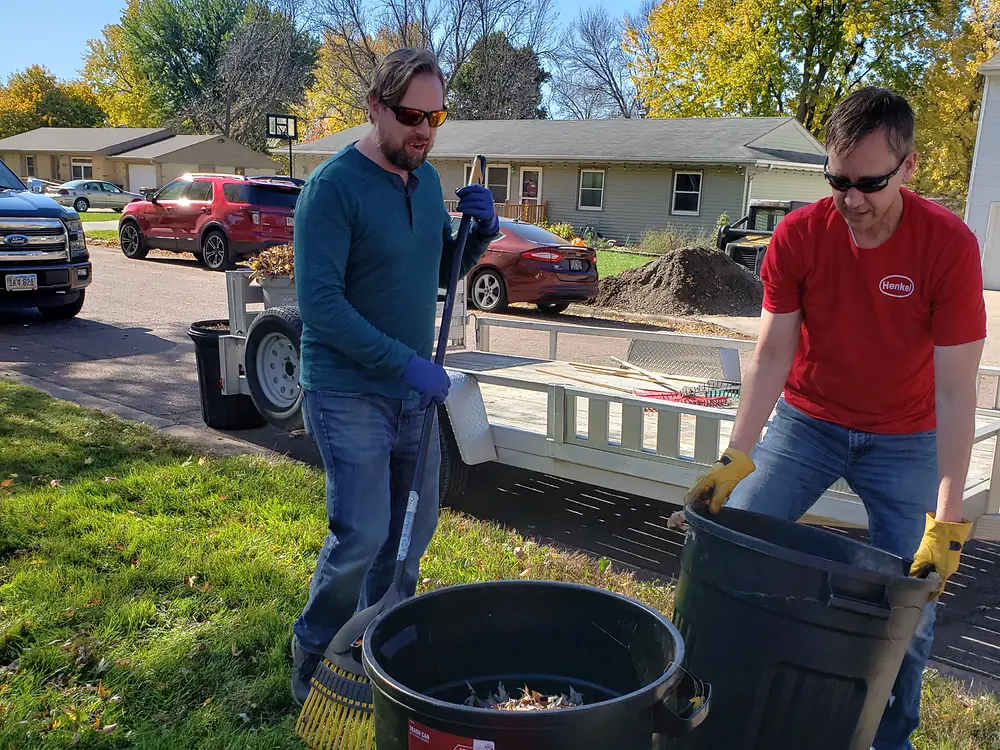 Men moving garbage cans