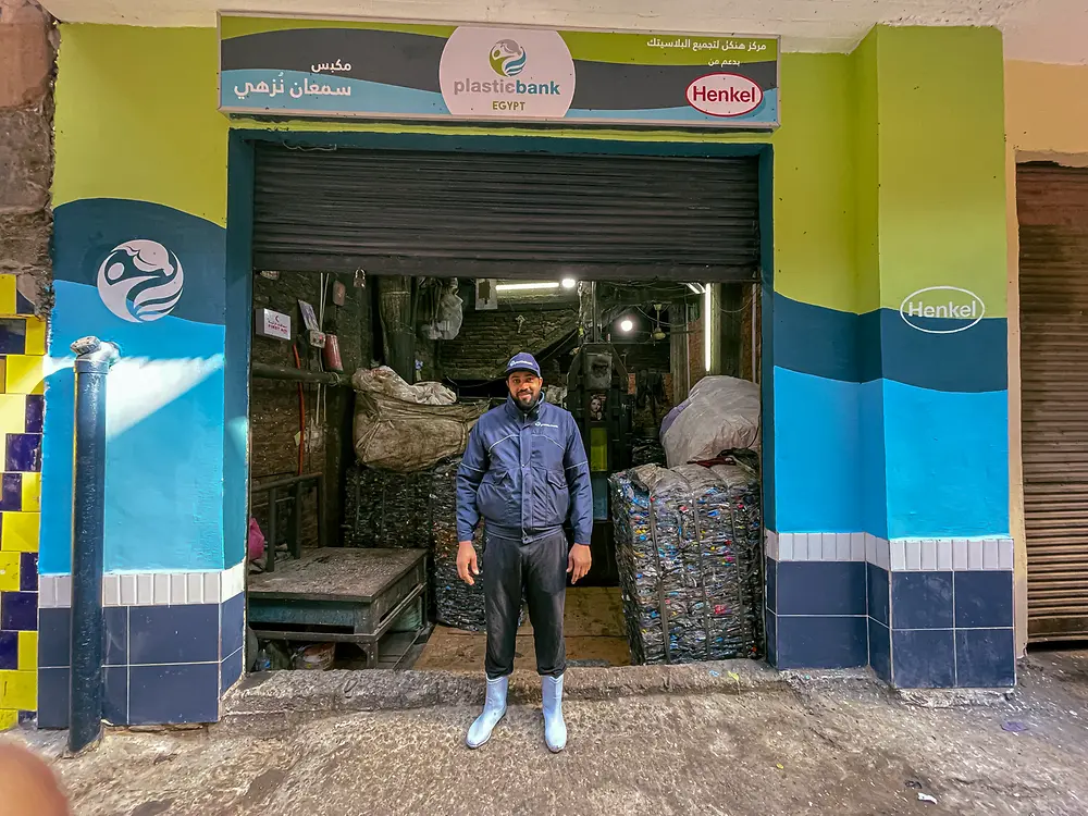 Worker posing at the entrance of a Plastic Bank Egypt collection center