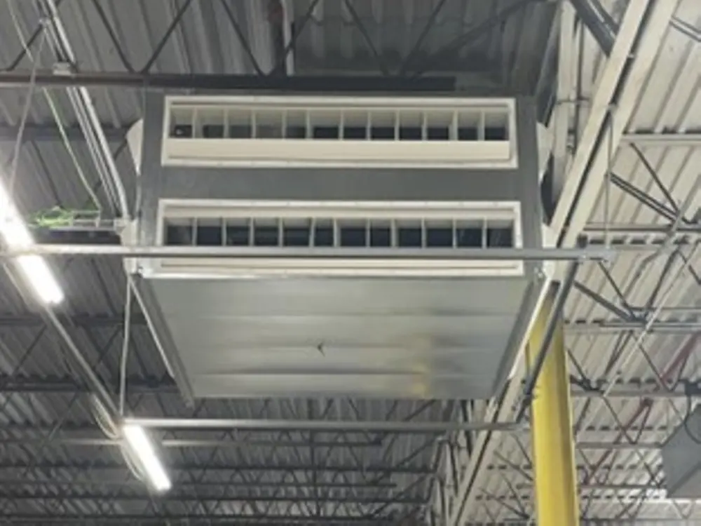 Air unit installed into a manufacturing facility's ceiling vaults.
