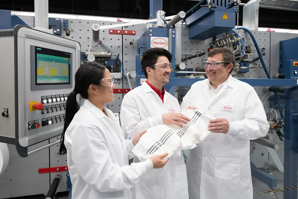 Three Henkel scientists standing in the Bridgewater Technology Center holding smart diaper solutions.