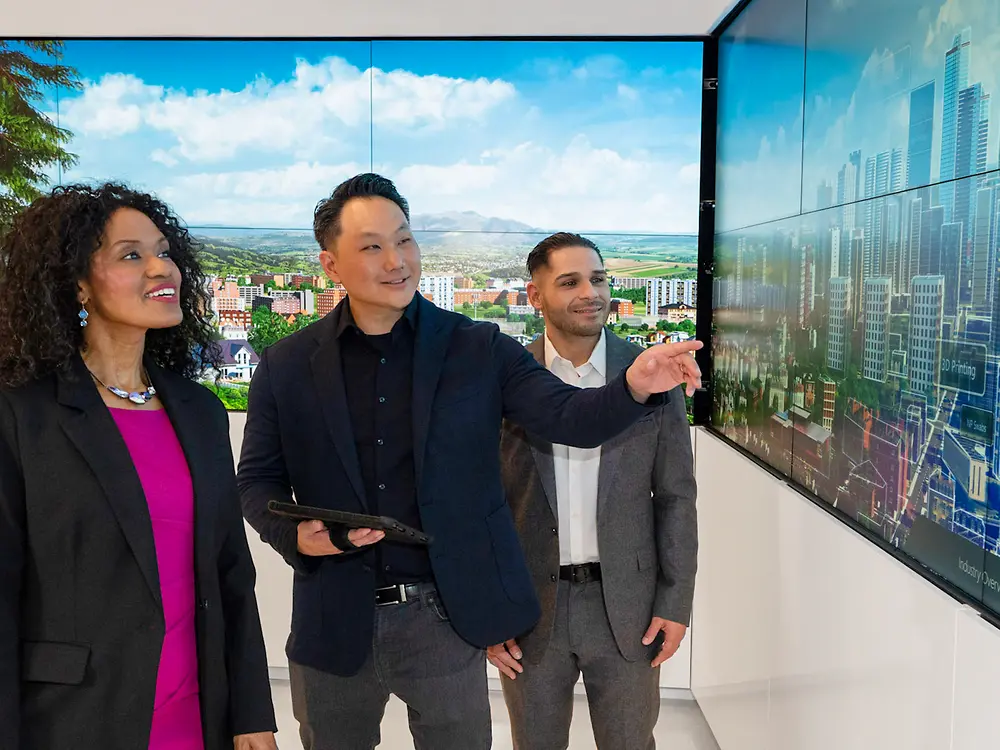 A customer experience tour guide presents the Adhesive Technologies portfolio to customers in the Infinity Room.