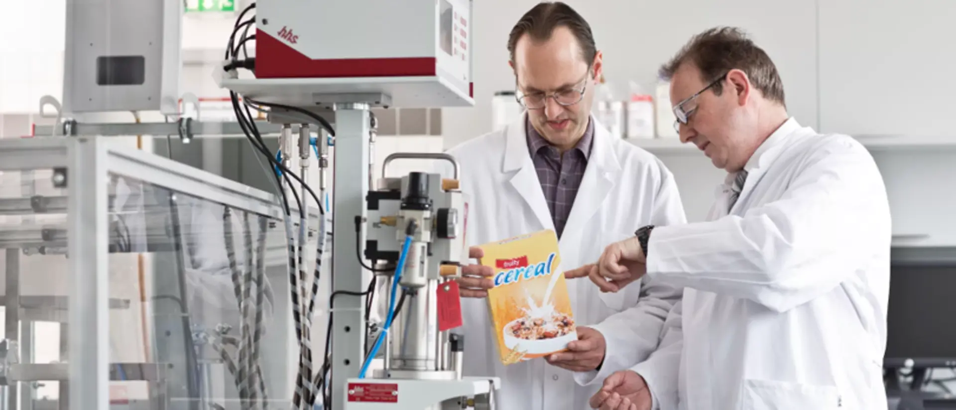 A photo of Henkel employees checking packaging adhesives.