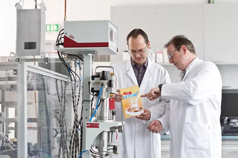 A photo of Henkel employees checking packaging adhesives.