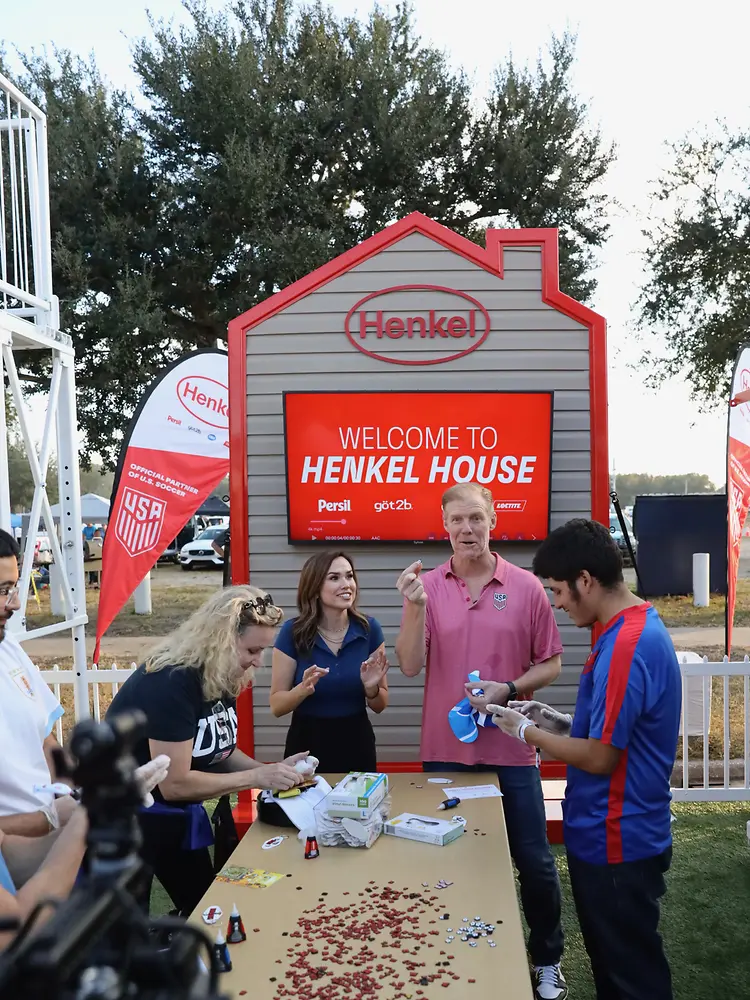 Alexi Lalas at a table with a group of other people with Loctite products