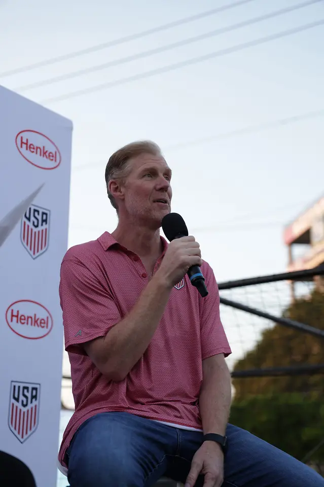Alexi Lalas speaks to a group of people at the Henkel House