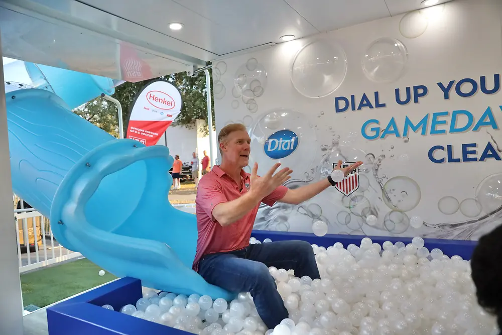 Alexi Lalas plays in the Dial brand ball pit in the Henkel House
