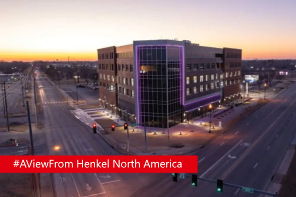 Henkel Bentonville office building illuminated with purple lights.