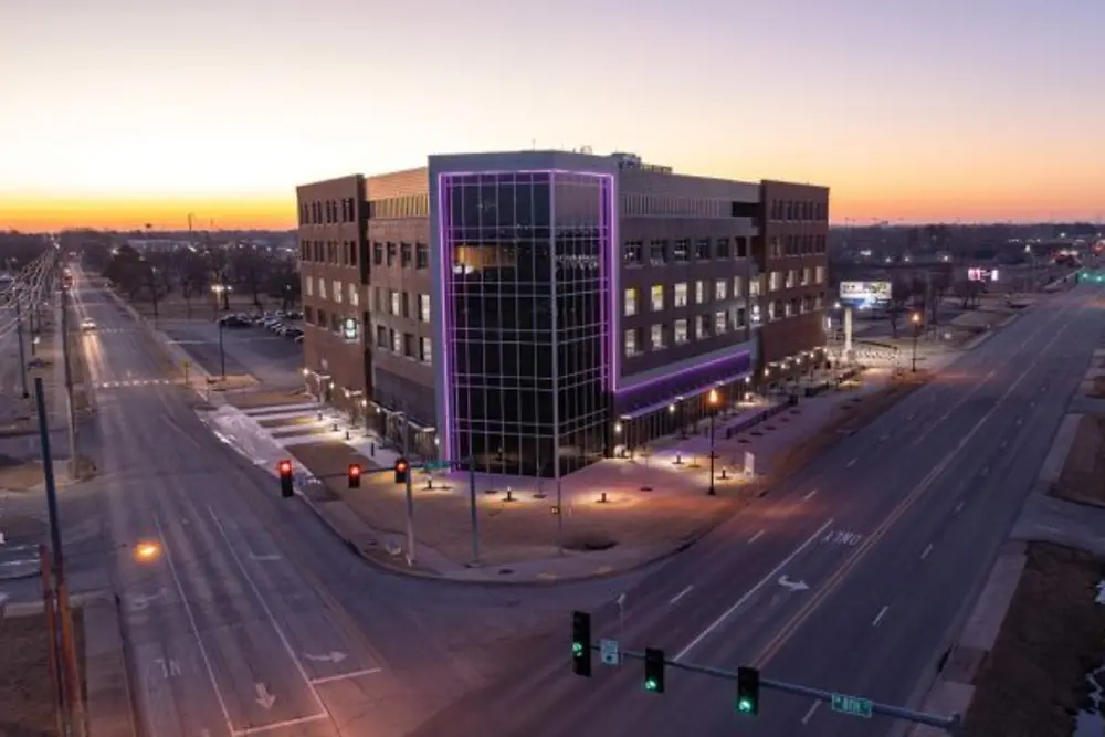 Henkel Bentonville office building illuminated with purple lights.