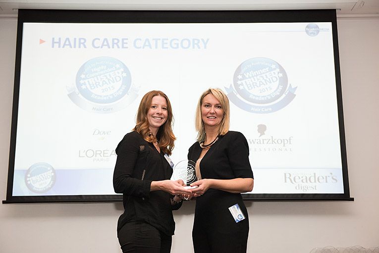 Jodie Lynch (left) receiving the Most Trusted Brand Award from Sheron White 