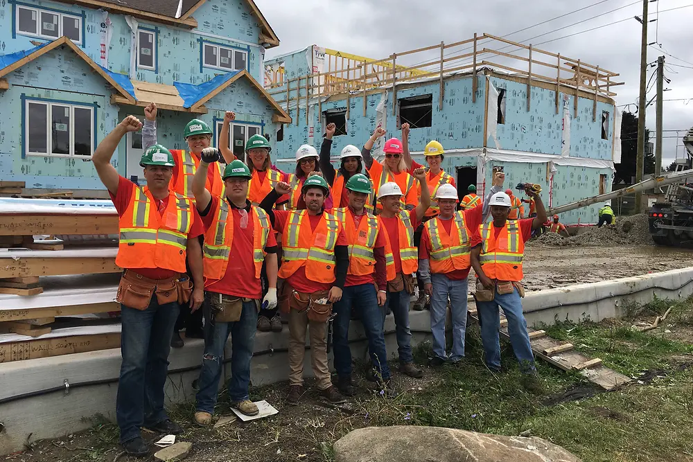 Henkel volunteers from our Mississauga, Canada office give a cheer at the start of their day building townhouses with Habitat for Humanity®.